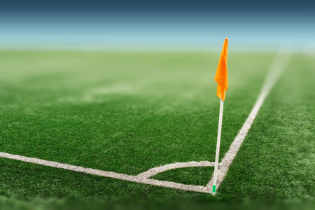 Green sports field with artificial grass. View from the corner of the orange flag on the football field. The layout of the football field in perspective.の写真素材