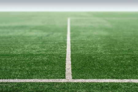 Green sports field with artificial grass, football field perspective.の写真素材