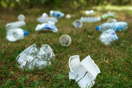 A pile of plastic on green grass, a problem in the natural environment, pollution of nature is not...