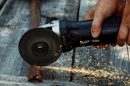 A man in working form is working on production, factory physical labor, a man is holding a...