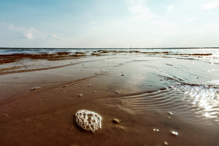 Sea ocean water wave foam sand beach horizon sky storm fog mist aqua cyan turquoise texture backgroundの写真素材