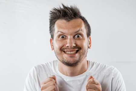 a man with a crazy look, a smile. The insane thoughts are crazy, obsessed with the idea.