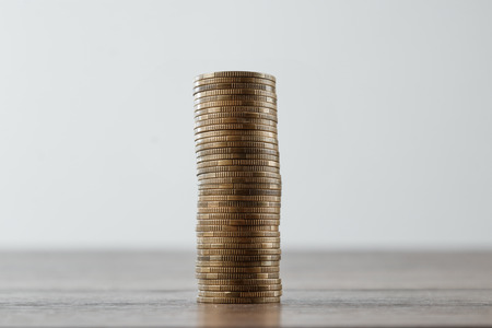 Columns of gold coins, piles of coins arranged on white background, business banking ideaの写真素材