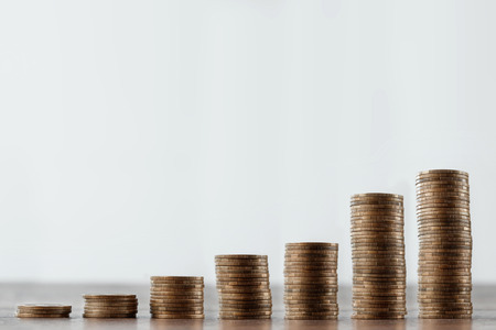 Deposit, coins on the table are laid out in stairs. The concept of bank and investment deposit, interest, money growth, bank deposit. Credit for business.の写真素材