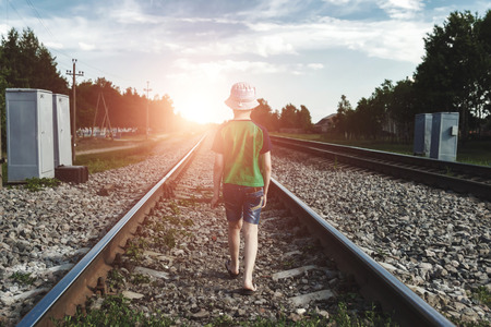 The child goes on rails, walks on rails. Danger, road, choice of profession.の写真素材
