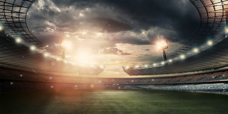 Stadium in the lights and flashes, football field. Concept sports background, football, night stadium. Mixed media, copy space.の写真素材