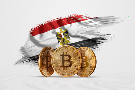 Crypto currency, gold coin BITCOIN BTC. Coin bitcoin against the background of the flag of Egypt. The concept a new currency, Blockchain Technology , a token.の写真素材
