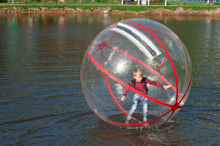 Attraction on the water, ZORB, the boy in a bowl on the water. Water attractions, rest, vacation,...