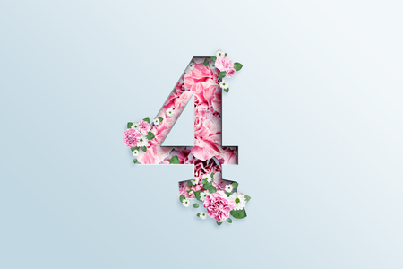 A figure of four consisting of pink flowers and green leaves on a light background. Spring background. Flat lay, copy space, mixed media, top view.の写真素材