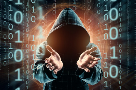 Young Hacker in a hood surrenders hands stretching forward, hacker attack, silhouette of a man, mixed media. The concept of a sudden attack, cryptography, data security.の写真素材