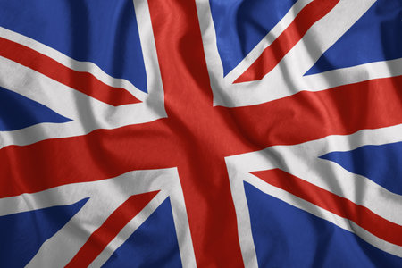 The British flag is flying in the wind. Colorful, national flag of Great Britain. Patriotism....