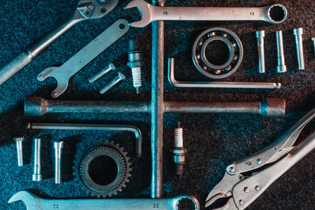 Bearings, wrenches, bolts on a dark background. view from above. Flat design. Automotive subjects.