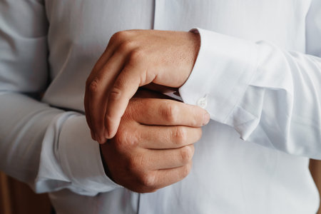 A man buttoning a blue jacket