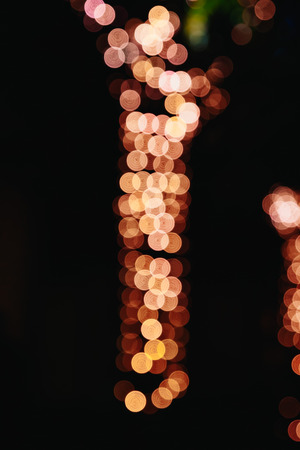 Blurred Christmas lights on a black background, bokeh. Light bokeh abstract. The concept of the new year 2018, holidays, vacation.の写真素材