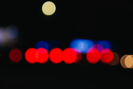Blurred Christmas lights on a black background, bokeh. Light bokeh abstract. The concept of the new...