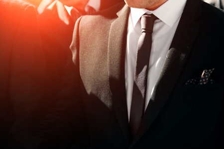 A man in a blue suit straightens his sleevesの写真素材