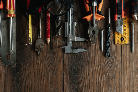 A construction tool on a brown wooden background. View from above. Picture background, screensaver....