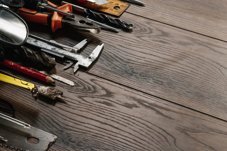 A construction tool on a brown wooden background. View from above. Picture background, screensaver....