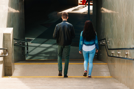 Man and girl go down in the subwayの写真素材
