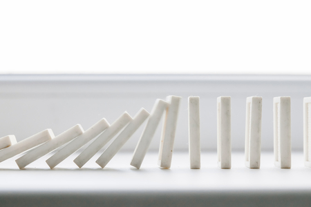 White domino, domino principle, on white backgroundの写真素材
