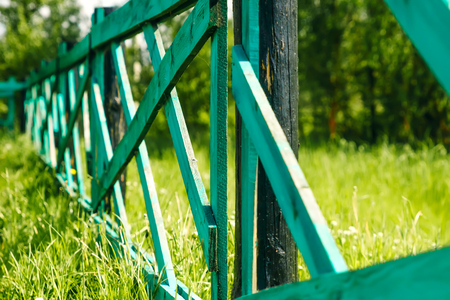 Old wooden fence and gate in green, grass landscape of Mongoliaの写真素材
