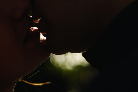 Guy and girl kiss large lips lips silhouettes. The guy is kissing the girl.の写真素材