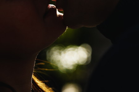 Guy and girl kiss large lips silhouettes. The guy is kissing the girl.の写真素材