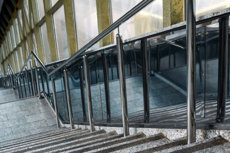 Metal fence made of chrome with handrails. Chromed metal railings. Shallow depth of field.