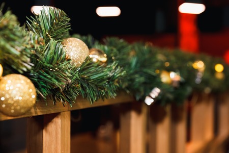 Christmas pine tree twigs and decorations garland isolated on whiteの写真素材