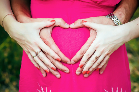 Closeup of couple making heart shape with handsの写真素材