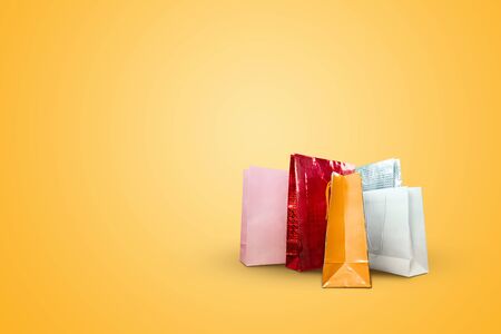 Packages from stores on a yellow background. Let's go shopping. The problem in shopping, obsession, discounts.の写真素材