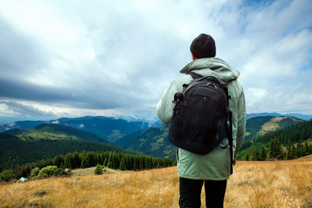Male tourist enjoying the mountainous terrain. The concept of active tourism, recreation, the Carpathians. Copy space.の写真素材
