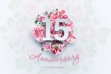 Creative background lettering 15 numbers and anniversary celebration text on pink flowers background. Anniversary concept, birthday, celebration event, template, flyer.の写真素材