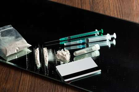A bunch of different drugs, syringes, pills on the table. Social problem, drug addiction, death,...