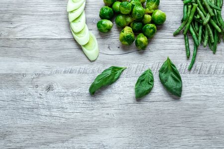 Fresh green food on a light table. Avocados cucumbers cabbage apples beans kiwi onions broccoli. The concept of healthy food, detox vegetarianism. Copy space flat layの写真素材