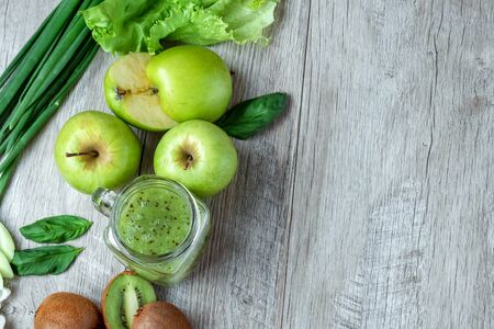 Fresh green food on a light table. Avocados cucumbers cabbage apples beans kiwi onions broccoli. The concept of healthy food, detox vegetarianism. Copy space flat layの写真素材