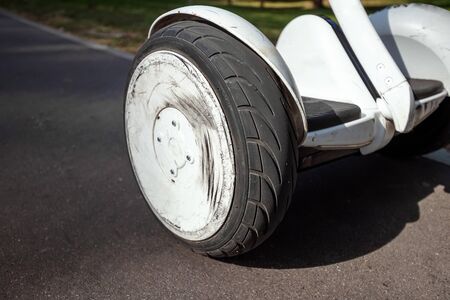 White hoverboard or self-balancing scooter in the park close-up. Technology, future, copy space.の写真素材