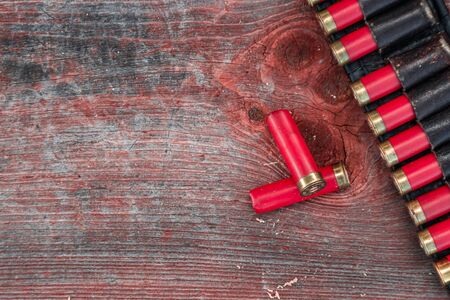 Hunting cartridges in patronage are lying on a wooden table close-up. The hunting period, the season is openの写真素材
