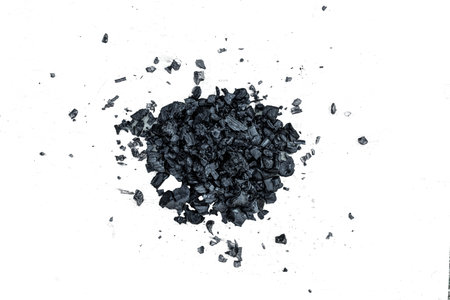 A pile of dark coal on a white background, coal mining, fossil fuel, environmental pollution