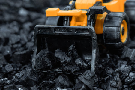 Loader bucket with coal, open pit coal mining, transport and logistics, copy space. Fossil fuels,...