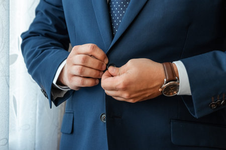 Hands of a businessman, close-up, buttons on a jacket. Concept of business styleの写真素材