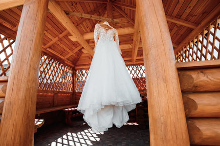 composition - a wedding dress on a gray blue wall with decor and accessories. The concept of marriage, family relationships, wedding paraphernalia