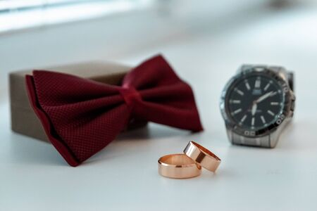 Wedding accessories, shoes, watches, rings, bow tie. The concept of marriage, family relationships wedding paraphernaliaの写真素材