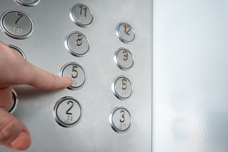 Female hand, finger presses the elevator button. up the career ladder