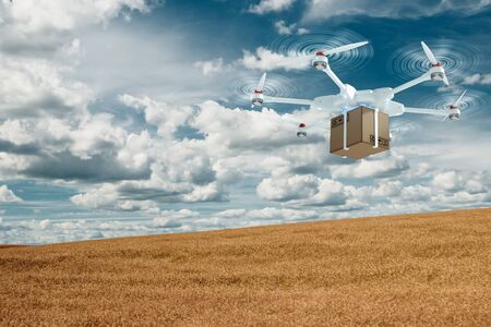 White flying drone with a cardboard box on a sky background. drone for delivery. The concept of fast delivery, technology. copy spaceの写真素材