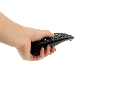 black remote control in hand isolated on white background.