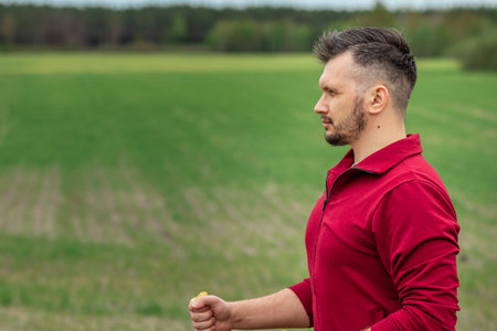 Sports, outdoor activities, Nordic walking, a man with sticks close-up. The concept of a healthy lifestyle, cardio training. Copyspaceの写真素材