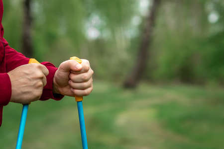Nordic walking, sticks, hands close-up. The concept of a healthy lifestyle, cardio training. Copyspaceの写真素材