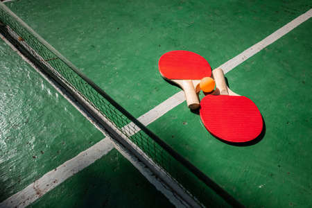 The concept of sports games, healthy lifestyle. Rackets for for table tennis and orange balls. Copy space, soft focusの写真素材
