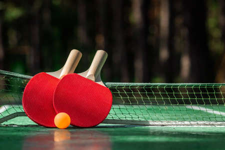 The concept of sports games, healthy lifestyle. Rackets for for table tennis and orange balls. Copy space, soft focusの写真素材